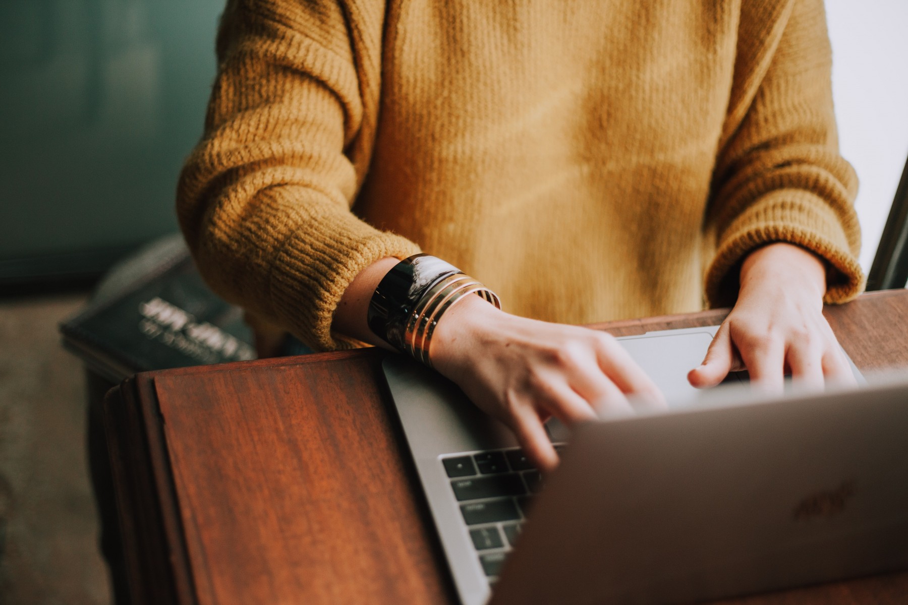 Person typing emails from laptop